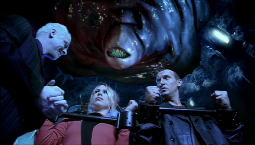Simon Pegg as The Editor, Billie Piper as Rose Tyler and Christopher Eccleston as The Doctor in Doctor Who - The Long Game (BBC1, 2005).
